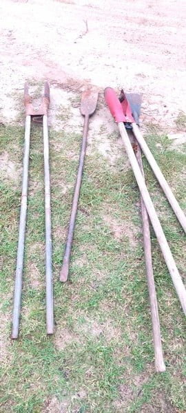 Various tools laid out for a reforestation project in Chuyachuya, Chazuta, including shovels, rakes, and gardening equipment